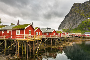 Fototapeta na wymiar Typical red fishing huts called Rorbu in town of Reine on Lofoten islands, Norway