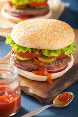burger with beef patty lettuce onion tomato ketchup