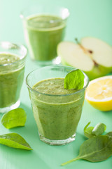 healthy green smoothie with spinach leaves apple lemon