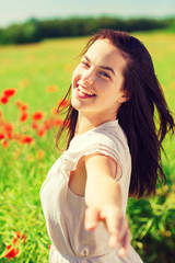 Fototapeta na wymiar laughing young woman on poppy field