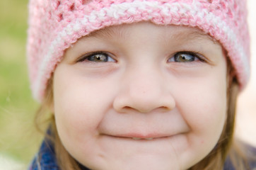 Close-up portrait of a smiling three-year girl