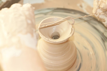 Female hands working on pottery wheel