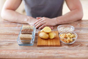 close up of male hands with carbohydrate food