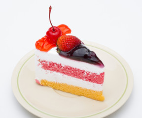Piece of cake with fresh fruit isolated on white background.