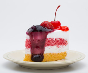 Piece of cake with fresh fruit isolated on white background.