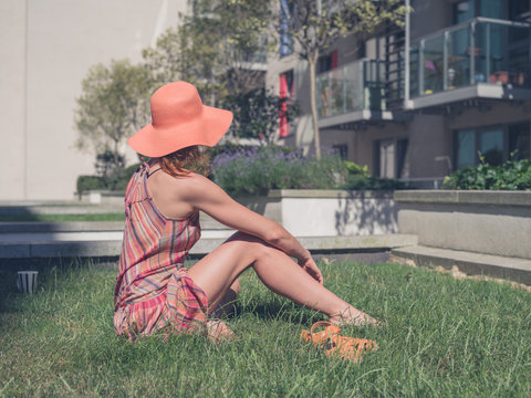 Young woman relaxing outside apartment block
