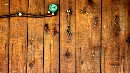 vintage key on wooden wall with power outlet