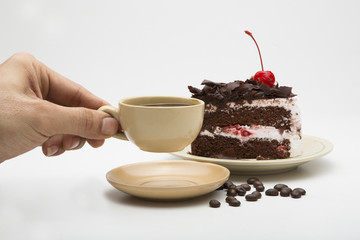 cup of coffee and delicious cake on white background