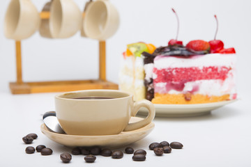 cup of coffee and delicious cake on white background