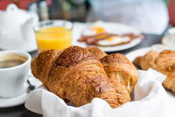 Breakfast with coffee and croissants on table