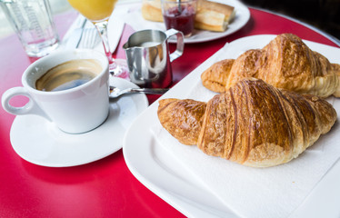 Breakfast with coffee and croissants on table