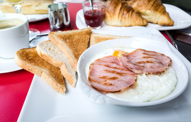 Breakfast with coffee and croissants on table