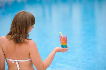 girl with cocktail in the swimming pooll