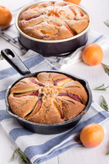 Two homemade pie with peaches, apricots and rosemary