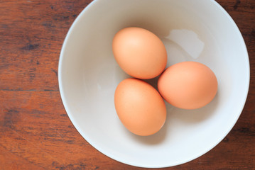 Three eggs on white disk