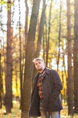  man wearing a coat in the autumn park