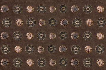 Brown suede background with metal buttons closeup