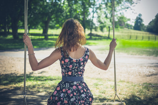 Young woman sitting on a swing