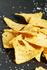 Nachos and salt on a dark background, selective focus