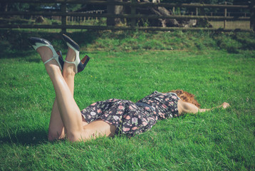 Young woman lying in the grass on a summer day