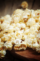 Sweet caramel popcorn in a wooden bowl, selective focus