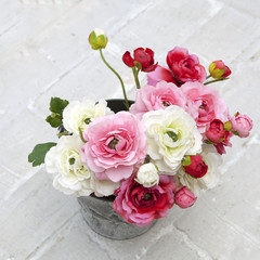 beautiful and delicate bouquet of buttercups in a zinc vase