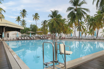 Swimming pool facing the lagoon in a tropical hotel