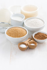 Ingredients for baking muffins on a white wooden background