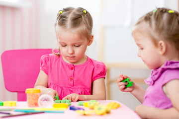 Little girls creating from play dough