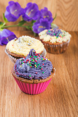  Cupcakes  decorated with berries and wild flowers
