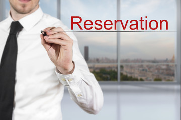 businessman writing reservation in the air