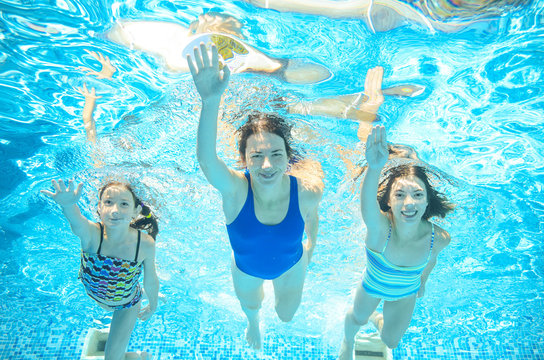 Family swim in pool underwater, happy active mother and children have fun in water, sport 