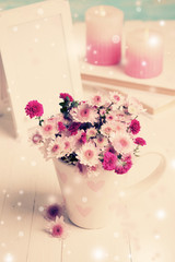 Beautiful flowers in cup on table on light background