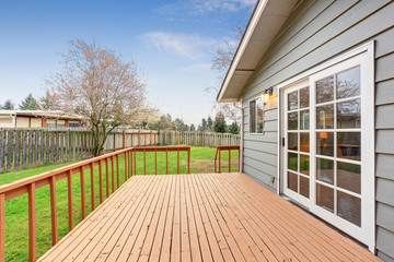 Lovely back yard with deck and grass.