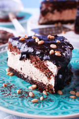 Delicious chocolate cake with icing in plate on table, closeup