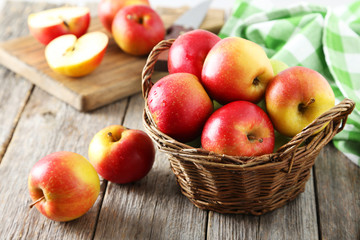 Fototapeta na wymiar Red apples in basket on grey wooden background