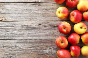 Red apples on grey wooden background