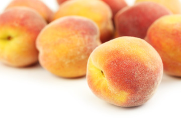 Fresh peaches fruit on a white background