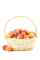 Fresh peach fruit in basket on a white background