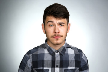 Fototapeta premium Portrait of young man on gray background