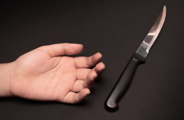 Sharp Knife Beside A Hand