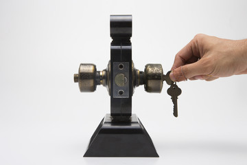 Aluminium door knob on the black door white background.