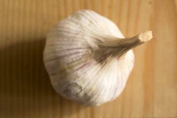 Garlic bulb on wooden table, closeup