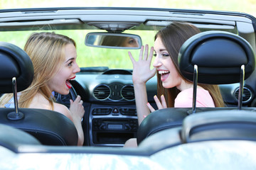 Fototapeta na wymiar Two girls in cabriolet, outdoors