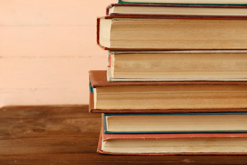 Stack of books on wooden background