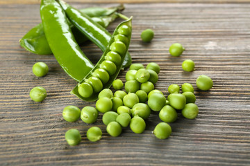 Fresh green peas on wooden table, closeup