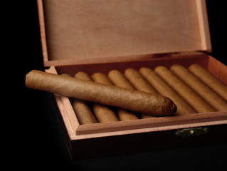 Fototapeta na wymiar Cigars in box on black background