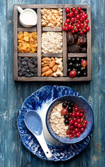 Granola, oatmeal, berries, nuts, and dried fruit for healthy breakfast. Top view