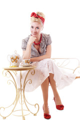 Pinup woman sitting at tea table