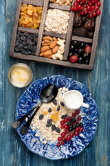 Oatmeal, granola, berries, nuts and dried fruits. Healthy breakfast. Top view